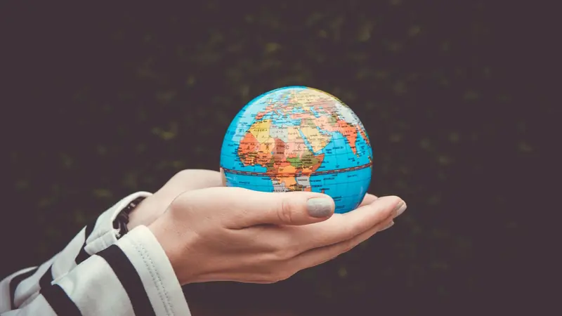 A globe lit from one side against a dark background
