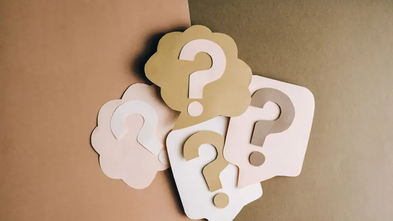 Question mark symbols repeated across a surface