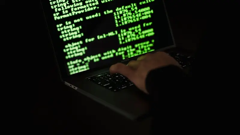 A dimly lit workstation with security tooling on screen