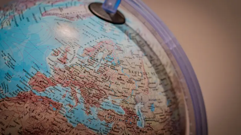A desk globe photographed against a plain background