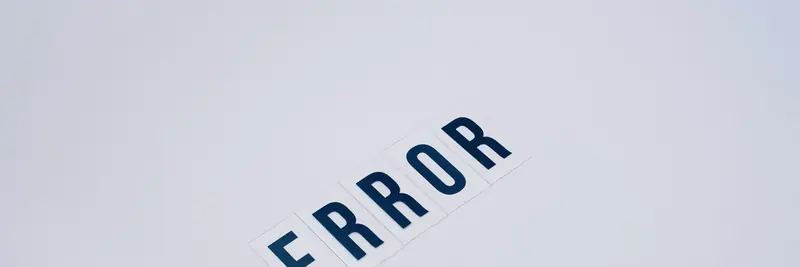 A warning sign photographed against a plain wall