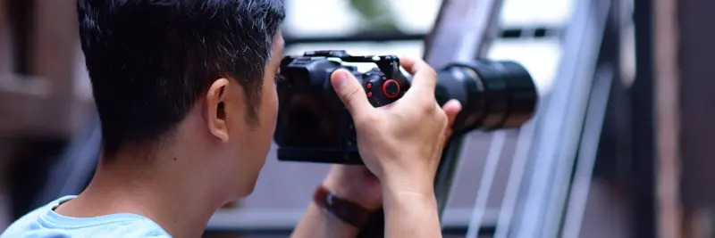 A camera and lens resting on a photographer's work surface