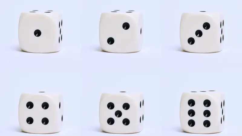 Several dice mid-roll on a wooden surface