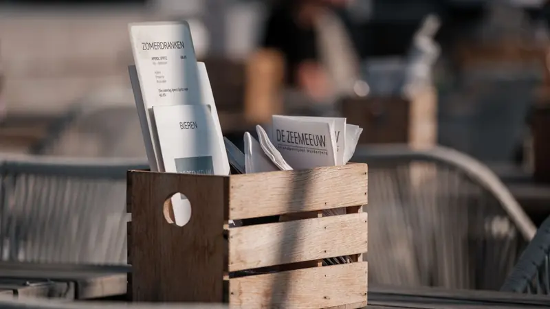 A café table set with a printed menu