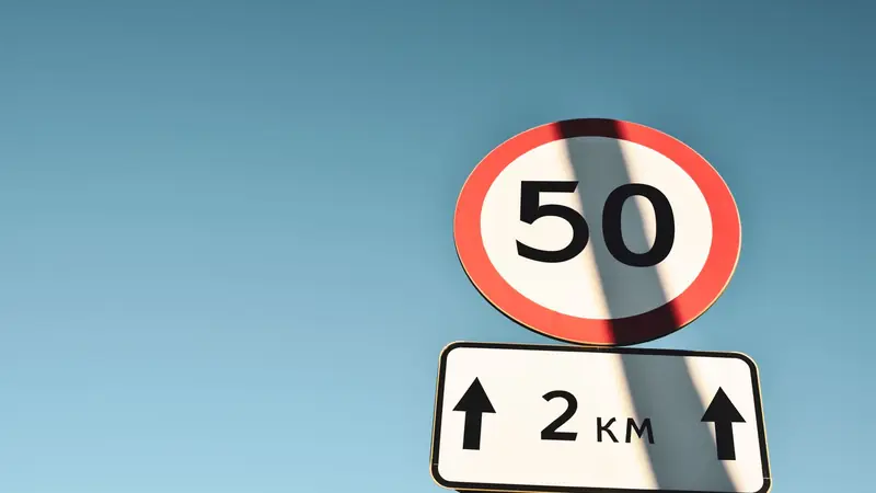 Road signs directing traffic along separate lanes