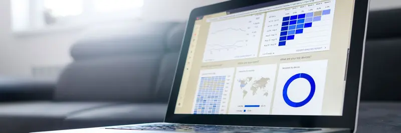 A laptop screen showing a web analytics dashboard with traffic charts