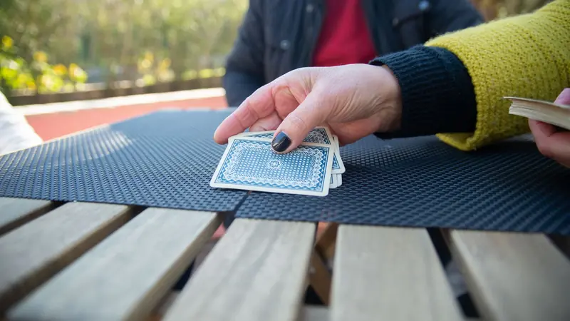 A deck of playing cards spread and shuffled across a table