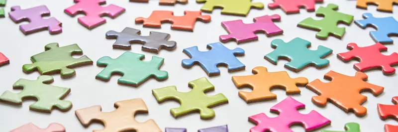 Jigsaw puzzle pieces partially assembled on a table