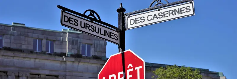 Street name signs mounted at a city corner