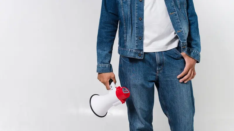 A megaphone held up against a bright background
